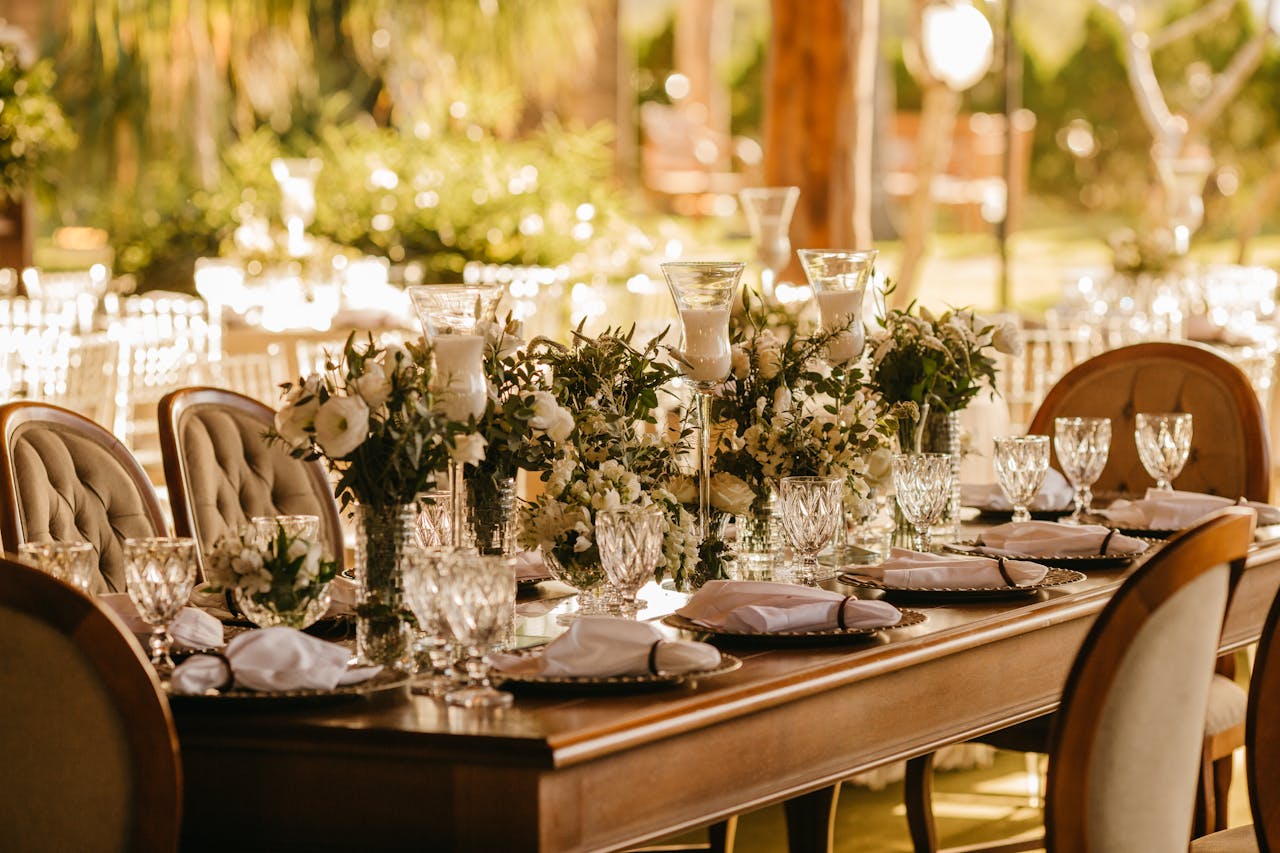 gallery-05 Elegant outdoor wedding reception with beautifully set table, flowers, and glasses.