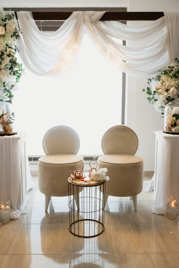gallery-03 Beautifully decorated seating area for an engagement ceremony with luxurious chairs and floral decor.